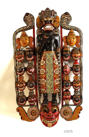 view Sinhalese mask used in exorcism and showing the heads of eighteen disease-spreading demons on either side of the central figure.