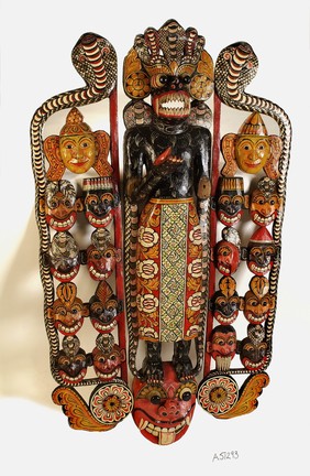 Sinhalese mask used in exorcism and showing the heads of eighteen disease-spreading demons on either side of the central figure.