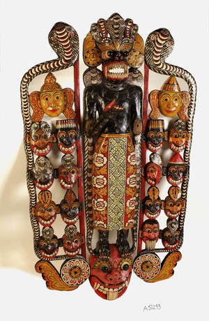 view Sinhalese mask used in exorcism and showing the heads of eighteen disease-spreading demons on either side of the central figure.