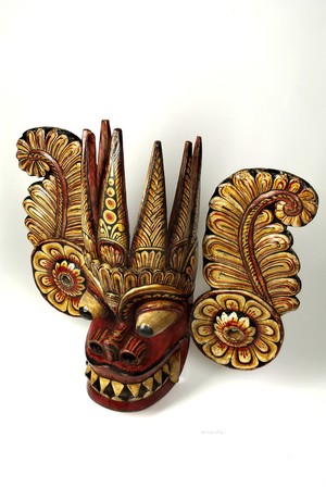 view Sri Lankan mask with a demon's face and ear-pieces.