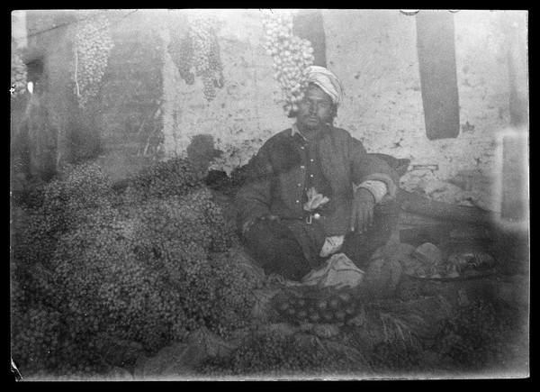 Shopkeeper sitting with his stock