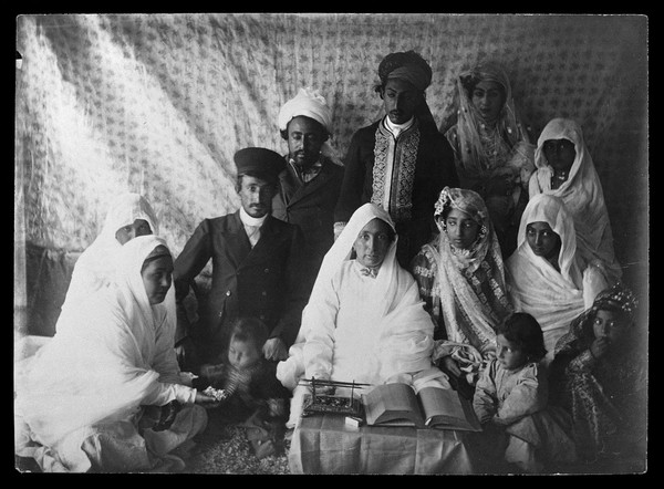 Well dressed group of people, possibly a marriage ceremony.