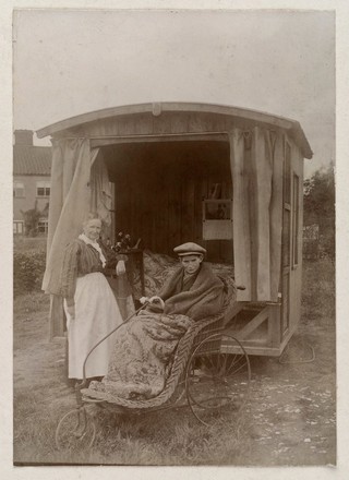 An invalid boy in a Bath chair outside an open air sleeping-chalet. Photograph by W. Ames, ca. 1900.