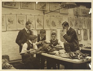 view The interior of a dissecting room: five students and/or teachers dissect a cadaver. Photograph, ca. 1900 (?).