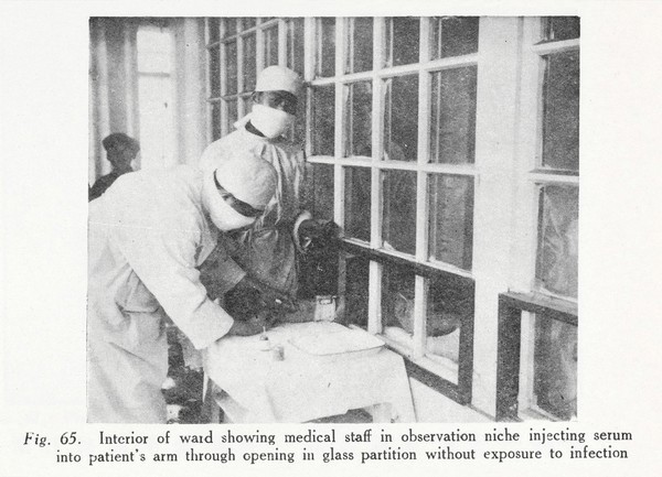 Interior of ward showing medical staff in observation niche