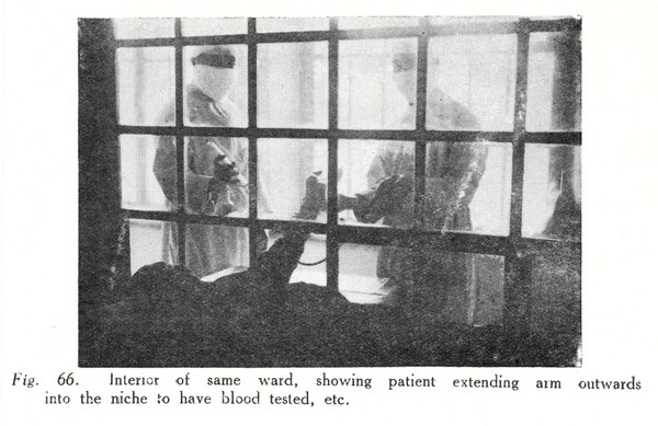 Interior of ward, showing patient extending arm outwards