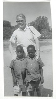 Photograph of Denis Burkitt with 2 young patients.