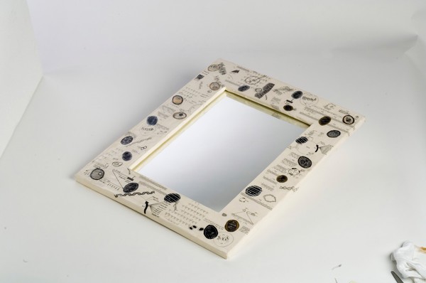 A mirror in which the surrounding world is copied by reflection, framed with formulae associated with the cloning of biological organisms. Mixed media by Sophie Dauvois, 1998.