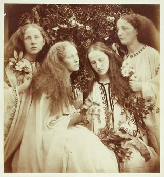 Four young women holding flowers. Photograph by J.M. Cameron, 1868.