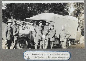 view World War One: soldiers in France carrying a wounded man to a dressing station. Photograph, 1916.