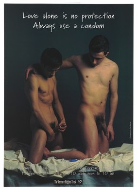 Two men prepare to have sex as one man puts on a condom; a tube of lubricant lies beside them; an advert for safe sex by the Terrence Higgins Trust. Colour lithograph.