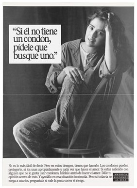 A woman sits sideways on a chair with one knee up and one elbow leaning against the back of the chair with the words "Si él no tiene un condón, pídele que busque uno"; a poster from the America responds to Aids advertising campaign. Black and white lithograph.