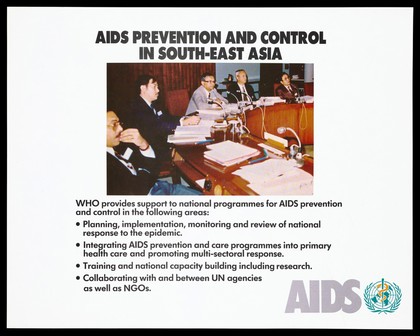 Men sitting at desks with speakers representing a World Health Organization meeting about AIDS prevention programmes in South-East Asia with a list of support activities provided by the organization. Colour lithograph, ca. 1995.