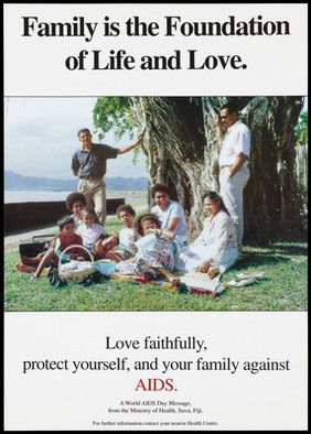A large Fijian family having a picnic beneath a tree with a message to protect your family against AIDS; a World AIDS Day message in an advertisement by the Ministry of Health, Suva, Fiji.