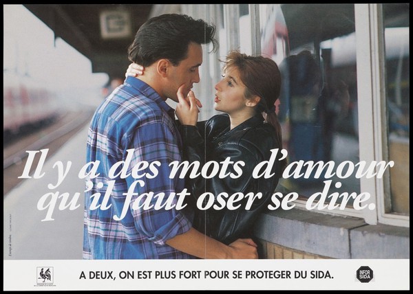 A woman touches the face of a man on the platform of a train station; representing an advertisement for information about AIDS by the Ministère de la Santé de la Communauté française, Belgium.