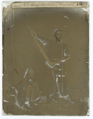 Canton (Guangzhou), Kwangtung province, China: street gamblers. Photograph by John Thomson, 1869.