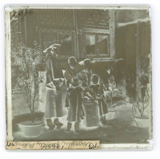 China: a Manchu lady with her daughter in-law and grandchildren, Beijing. Photograph by John Thomson, 1869.