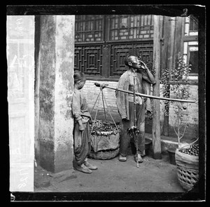 view Peking, Pechili province, China: a travelling fruit-seller. Photograph by John Thomson, 1869.