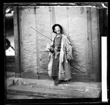 Peking, Pechili Province, China: a nightwatchman. Photograph by John Thomson, 1869.