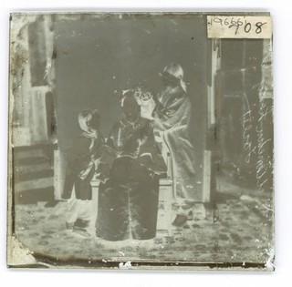 China: a Manchu lady having her hair dressed by her servant girl, Beijing. Photograph by John Thomson, 1869.