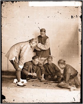 Canton, Kwangtung (Guangdong) province, China: street gamblers. Photograph by John Thomson, 1869.