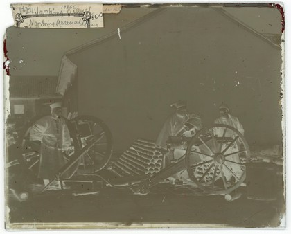 Nanking, Kiangsu province, China: three men examining a gun at the arsenal. Photograph by John Thomson, 1871.