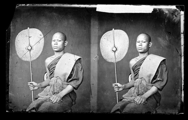 A Thai monk holding a fan. Photograph by John Thomson, 1865.