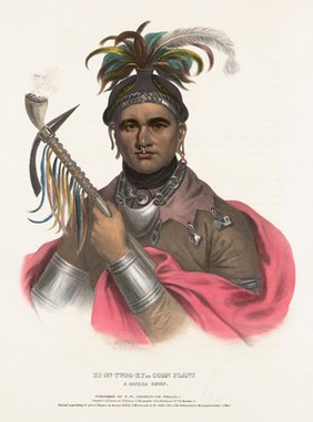 Cornplanter, a leader of the Seneca tribe, holding a smoking pipe with pipe attachments and axe-blades. Colour lithograph by J.T. Bowen after F. Bartoli, 1836.