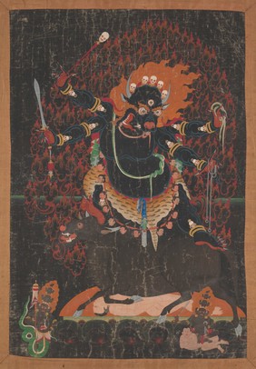 Yama, Buddhist god of death, with the head of a buffalo bedecked with skulls and flames, stands on a bull crushing a man lying on his back. Distemper painting.