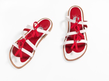 Sandals made of red and white straps incorporating the red ribbon device associated with AIDS. Pair of sandals, 1994.