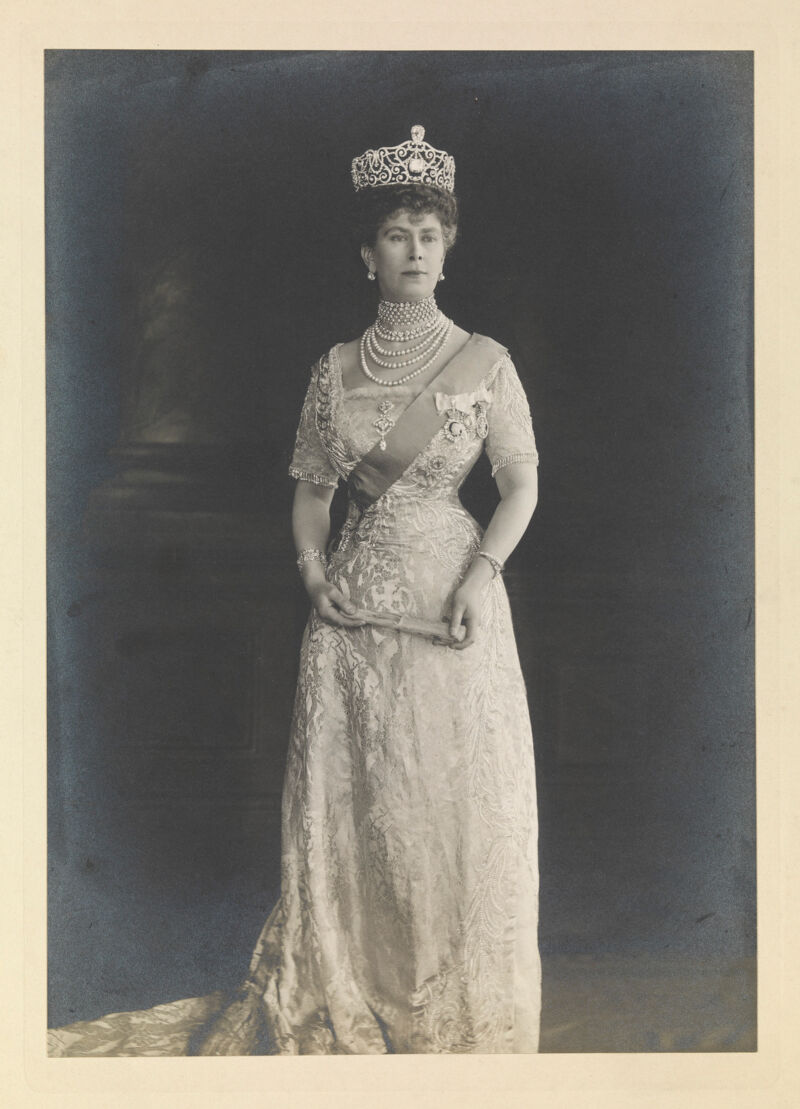 Queen Mary (May of Teck) standing, wearing a tiara and holding a folded ...