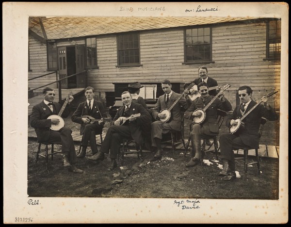 A band of seven blinded soldiers playing the banjo. Photograph, ca. 1919.