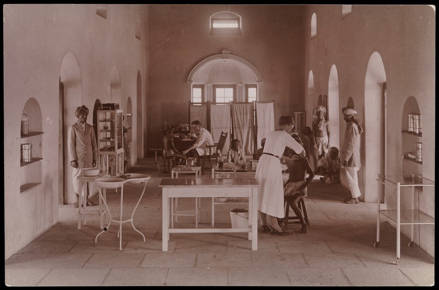 Dichpali, Hyderabad: doctors treating leprosy patients in one of the hospital wards. Photograph by R. Howett, 19--.