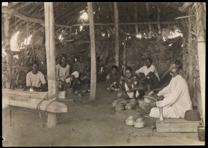 view South India: boys and young men with leprosy making brass and copper utensils. Photograph by R. Howett, 19--.