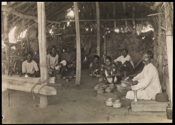 South India: boys and young men with leprosy making brass and copper utensils. Photograph by R. Howett, 19--.