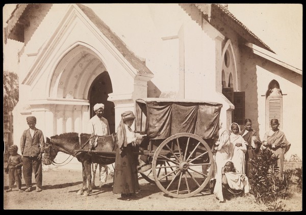 South India: a cart drawn by a donkey bringing women patients to a medical mission. Photograph by A.R. Slater, 19--.