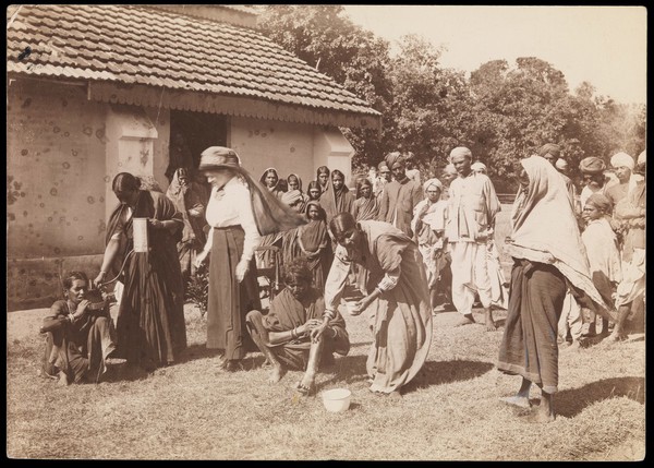 South India: treatment of patients outside a medical mission, being watched by local people. Photograph by A.R. Slater, 19--.