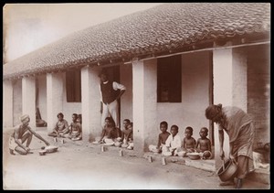 view Poonamalee, South India: boys having a meal at an orphanage. Photograph, ca. 1924.