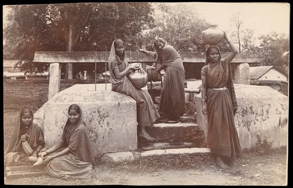 Hassan, Karnataka, India: young women fetching water from a well at an orphanage. Photograph.