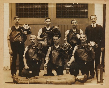 Wattstown, Wales: a rescue brigade of the coal mine, with breathing equipment and a training dummy. Photograph by A. Davies, 1914.