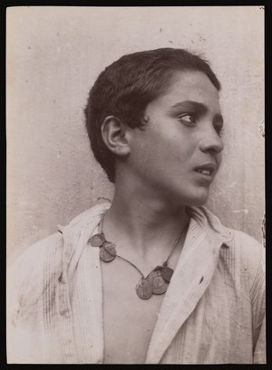 view A Sicilian boy, head and shoulders, with a necklace of coins. Photograph by W. von Gloeden, 1900.