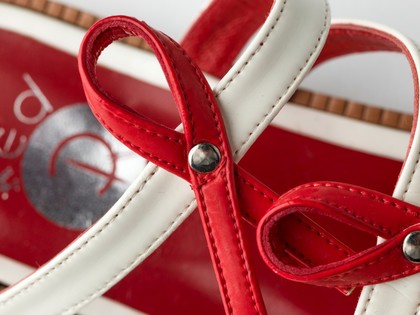 Sandals made of red and white straps incorporating the red ribbon device associated with AIDS. Pair of sandals, 1994.