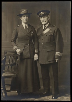 Sir James Cantlie and Lady Cantlie (both standing) in St. John's Ambulance uniform. Photograph by F.C. Stoate, ca. 1914/1918.