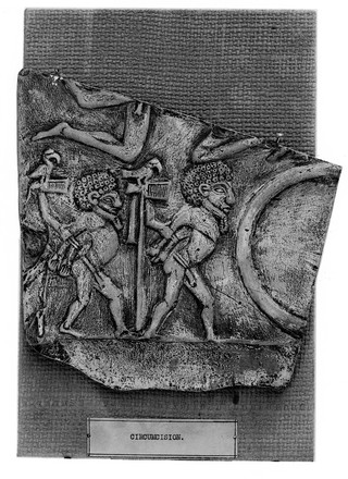 A plaque showing two male circumcision figures