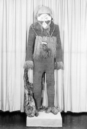 African medicine man, string knitted suit, black & white mask