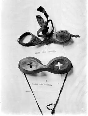Glass and wooden snow goggles with slits.
