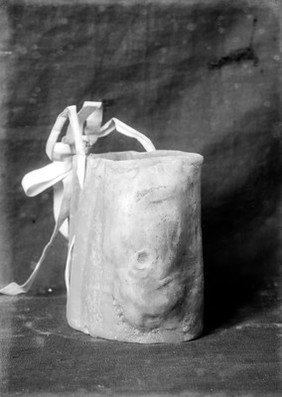 Wax ex-voto. Hollow circular piece with bow. Musee Etnographique, Palermo.