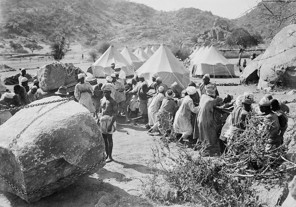 Jebel Moya: natives hauling on rope, tents in the background