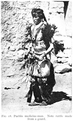 A Pueblo Medicine man with rattle made from a gourd