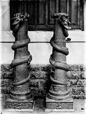 Indian or Persian: 2 pedestals with snakes entwined.